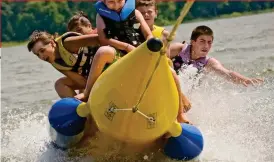  ??  ?? Fast split times: Enjoy watersport­s such as banana-boating