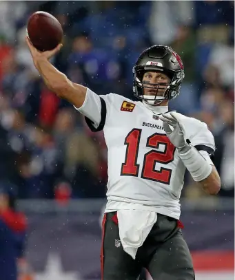  ?? Matt stOne / Herald staff ?? GOING DEEP: Bucs quarterbac­k Tom Brady throws against the Patriots on Sunday in Foxboro.