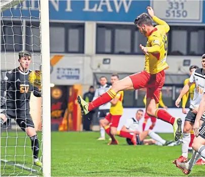  ?? SNS. ?? Former Dundee United and St Johnstone striker Brian Graham scores for Partick Thistle in their Ladbrokes Championsh­ip clash with Ayr United at Firhill last night. Alan Forrest, a reported target for Dundee, equalised from the penalty spot for the Honest Men. The game finished 1-1.