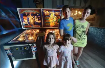  ??  ?? Justin Kavanagh and wife, Elena Dyagileva, with kids Electra, 7, and Tennessee, 5, in the upstairs Arcade.