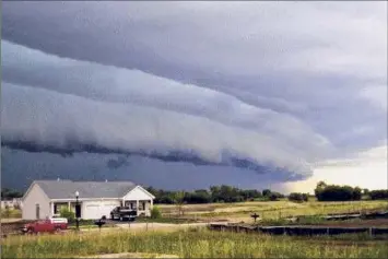  ?? Brittney Misialek / NOAA ?? A gust front “shelf cloud” is seen on the leading edge of a derecho-producing convective system in July 2008 in Hampshire, Illinois as the storm neared Chicago. The derecho had formed earlier in southern Minnesota. Meteorolog­ists say it is possible the destructiv­e storm that blew through the Capital Region Wednesday was a derecho.