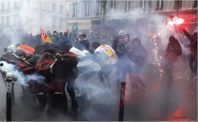  ??  ?? Flashpoint: Tear gas is used as protesters clash with police on the streets of Paris yesterday