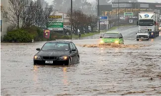  ?? PHOTO: STUFF ?? Cars drive through a flooded area of State Highway 1 in Timaru yesterday.