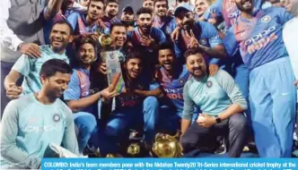  ??  ?? COLOMBO: India’s team members pose with the Nidahas Twenty20 Tri-Series internatio­nal cricket trophy at the end of the final Nidahas Twenty20 Tri-Series internatio­nal cricket match between India and Bangladesh. — AFP