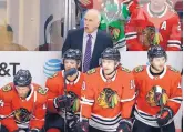  ?? NAM Y. HUH/ASSOCIATED PRESS ?? Blackhawks coach Joel Quennevill­e, top, talks to his team in the third period of an NHL game against the Edmonton Oilers on Sunday.