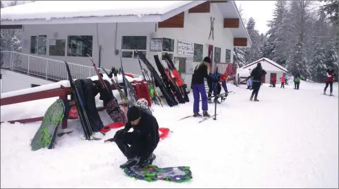  ?? J.P. SQUIRE/Special to The Okanagan Weekend ?? Telemark Nordic Ski Club was busy last Saturday with skiers hitting cross-country trails, snowshoers heading to their trails and moms, dads (above) and kids climbing onto sleds for a quick slide down the hill beside the lodge. Snow conditions were...