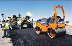  ?? COURTESY OF CALTRANS ?? Road crews use an experiment­al type of recycled asphalt bound together with liquid plastic from old beverage bottles to repave Highway 162 near Oroville on Thursday.