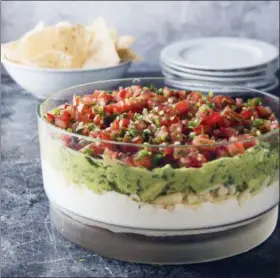  ?? JOE KELLER/AMERICA’S TEST KITCHEN VIA ASSOCIATED PRESS ?? This undated photo provided by America’s Test Kitchen shows ultimate seven-layer dip in Brookline, Mass.