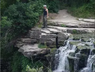  ?? SCOTT GARDNER, THE HAMILTON SPECTATOR ?? A man stands at the edge of Albion Falls Sunday. Recent signage and fencing by the city did little to deter people from accessing the popular, yet dangerous, spot.