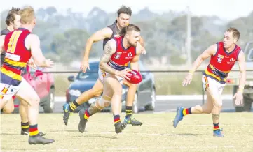  ??  ?? Nathan Fry bursts through the middle of the ground for Longwarry against the Tigers.