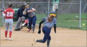  ?? AUSTIN HERTZOG - MEDIANEWS GROUP ?? Upper Perkiomen’s Morgan Lindsay hits a double down the left field line to scoring Jenna Sullivan, foreground, against Owen J. Roberts Wednesday.