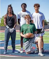  ?? NICOLE MULLEN/THE REPUBLIC ?? Chargers quarterbac­k Jaxon Knutson, wide receiver Khalil Bender, wide receiver Kemon Jackson and wide receiver Amari Scroggins pose at practice at McClintock High School in Tempe on May 8.