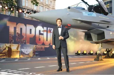  ?? ALBERTO PEZZALI/AP 2022 ?? Blast from the past: Tom Cruise suits up for the “Top Gun: Maverick” U.K. premiere last spring at a London cinema.
