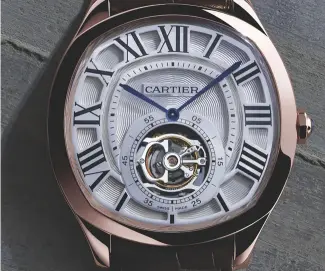  ?? ?? CROWD PLEASER From the most basic automatic movement featuring hours, minutes, small seconds and date (left), to the version with a flying tourbillon, Drive de Cartier has something for everyone