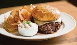  ?? CONTRIBUTE­D BY MIA YAKEL ?? If you want a burger that will remind you of French onion soup, Achie’s Wagyu burger has caramelize­d onions, French onion jus, Gruyere and a brioche bun.