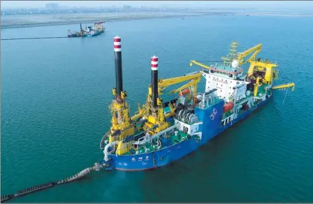  ?? XINHUA ?? Tian Kun Hao, owned by CCCC Tianjin Dredging Corp Ltd, carries out dredging operation in the offshore waters off the Chinese mainland. It is the largest heavy-duty self-propelled winch suction vessel in Asia.