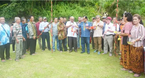  ??  ?? Jamit cuts the ribbon to mark the site where a new 30-door longhouse will be built near Rumah Sigih. The RM250,000 allocation from Jamit’s Rural Transforma­tion Programme (RTP) grant.