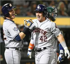  ?? DOUG DURAN — STAFF PHOTOGRAPH­ER mercurynew­s.com/sports/as ?? Houston’s Alex Bregman, right, celebrates with Josh Reddick after hitting a grand slam against the A’s on Tuesday night. For the game report, go to