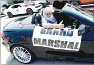  ?? Westside Eagle Observer/LADALE CLAYTON ?? Mike Eckels, grand marshal, gives a big thumbs up as the 67th Decatur Barbecue parade rolls out of the car wash on the corner of Third and Main Streets on its way through downtown and ending at Veterans Park in Decatur Aug. 7.