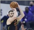  ?? RON SCHWANE — THE ASSOCIATED PRESS ?? The Cavaliers’ Kevin Love shoots over the 76ers’ Mike Scott during the first half April 1.