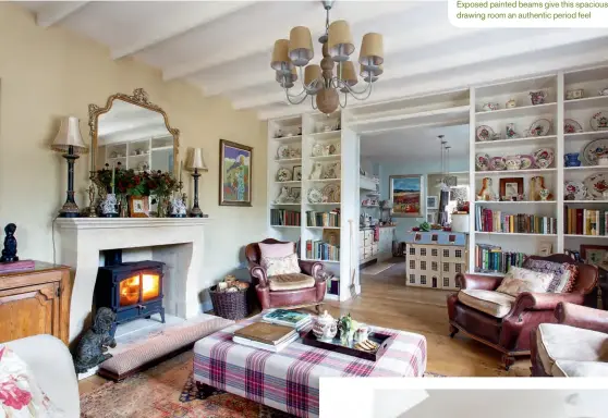  ??  ?? Exposed painted beams give this spacious drawing room an authentic period feel