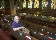  ?? Pittsburgh Post-Gazette ?? The Rev. Tom Hall, pastor of the First Presbyteri­an Church, sits in a side balcony at the 113-year-old church in Downtown.