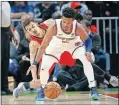  ?? [AP PHOTO/ JOHN BAZEMORE] ?? Atlanta Hawks guard Trae Young, rear, tries to steal the ball from New York Knicks guard Dennis Smith Jr. during the Knicks 106-91 win Thursday night.