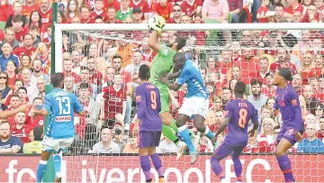  ?? — Reuters photo ?? Liverpool’s Alisson in action as he catches the ball following a Napoli free-kick.