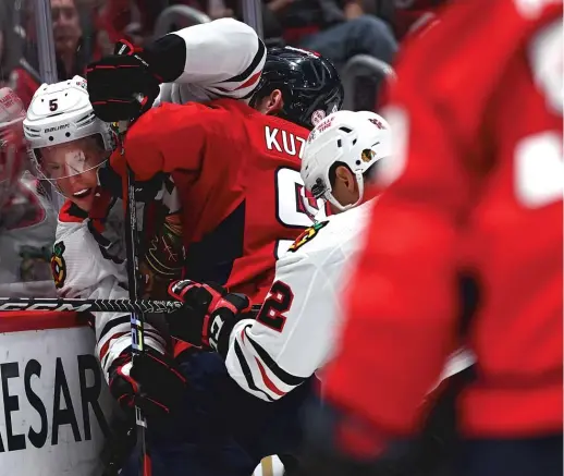  ?? GETTY IMAGES ?? Defenseman Connor Murphy, getting checked by the Capitals’ Evgeny Kuznetsov, says the Hawks do a great job of supporting causes in the community.