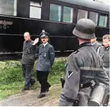  ??  ?? Hitler can be seen with the Foreign Minister von Ribbentrop as he walks alongside his special headquarte­r train Amerika, flanked by bodyguards