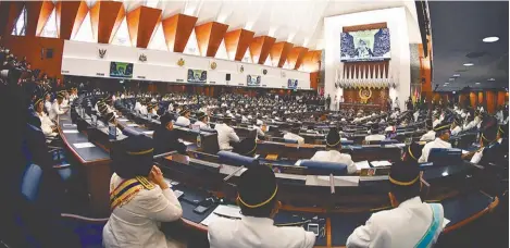  ??  ?? ... Parliament­arians listening attentivel­y as Yang di-Pertuan Agong Sultan Muhammad V delivers his royal address at the opening of the first session of the 14th Parliament yesterday.