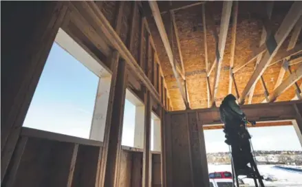  ??  ?? A constructi­on worker last week helps frame a house in Hilltop Pines, a new subdivisio­n in Parker. Home constructi­on continues at a brisk pace in Colorado, but builders can’t keep up with housing demand in the Denver metro area. Kenneth D. Lyons, The...