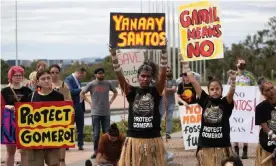  ?? Photograph: Mike Bowers/The Guardian ?? Protesters hold signs on the forecourt of Parliament House. Gomeroi traditiona­l owner Gwenda Stanley told the Canberra rally: ‘We’re going to fight this gasfield because it threatens to poison our people, our country.’