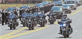  ??  ?? UNITED: Weymouth police salute the procession carrying police officer Michael Chesna’s body after he was shot and killed yesterday morning.