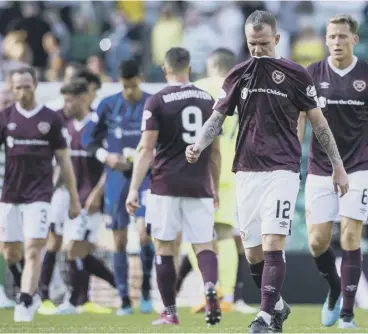  ??  ?? 0 Dejected Hearts players leave the field following a 3-1 defeat by Celtic at Parkhead last season.