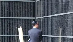  ?? (Bernadett Szabo/Reuters) ?? A MAN GAZES at the wall bearing the names of victims at the Holocaust Memorial Center in Budapest.