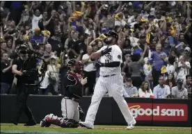  ?? MORRY GASH — THE ASSOCIATED PRESS ?? The Brewers’ Rowdy Tellez celebrates his two-run home run during the seventh inning in Game 1of Milwaukee’s NL Division Series against the Braves on Oct. 8.