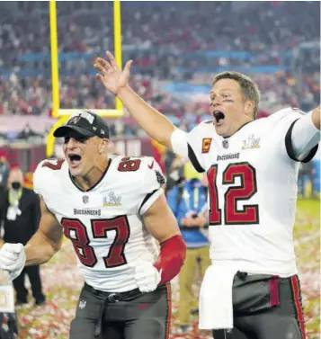  ?? (Photos: AP) ?? Tampa Bay Buccaneers tight end Rob Gronkowski (87), (left) and Tampa Bay Buccaneers quarterbac­k Tom Brady (12) celebrate together after the NFL Super Bowl 55 football game against the Kansas City Chiefs on Sunday, Feburary 7, 2021, in Tampa, Florida.