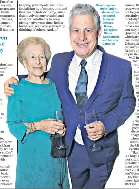  ??  ?? Never happier: Molly Parkin, above, at her colourful home in Chelsea. Below, partygoer Diana Mackintosh and her son Cameron