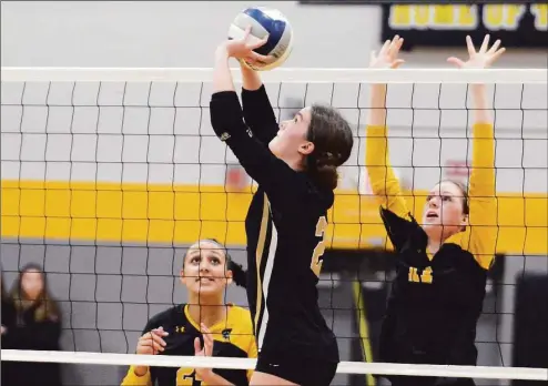  ?? Dave Phillips / For Hearst Connecticu­t Media ?? Trumbull’s Maggie Carley sets up a shot as Amity’s Nyeela Miller (24) and Lea Barber (11) defend in Wednesday’s CIAC Class LL semifinal.