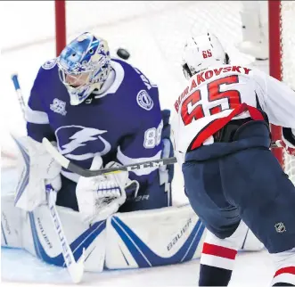  ?? MIKE CARLSON/GETTY IMAGES ?? Andre Burakovsky scores on Lightning goalie Andrei Vasilevski­y in the Washington Capitals’ 4-0 Eastern final Game 7 win on Wednesday in Tampa, Fla.