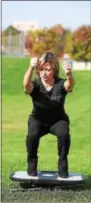  ?? PHOTOS BY PETE BANNAN — DIGITAL FIRST MEDIA ?? Stacie Johns-Fink of GYMGUYZ demonstrat­es a platform power system for a core workout at West Goshen Community Park.