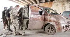  ?? — AFP ?? ALEPPO: Rebel fighters from the Jaish al-Fatah (or Army of Conquest) brigades get in a vehicle yesterday in the neighborho­od of Dahiyet al-Assad after they retook control of the area.