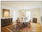 ?? ?? The formal dining room offers two windows and space for a table beneath a candle lantern chandelier.
