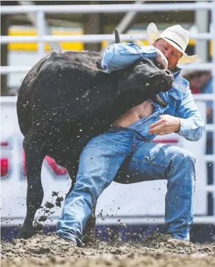  ?? AZIN GHAFFARI ?? Curtis Cassidy from Donalda won the Steer Wrestling Performanc­e on the third day of Calgary Stampede Sunday. “My steer actually ran his inside horn in my shirt when I was catching him,” Cassidy said.