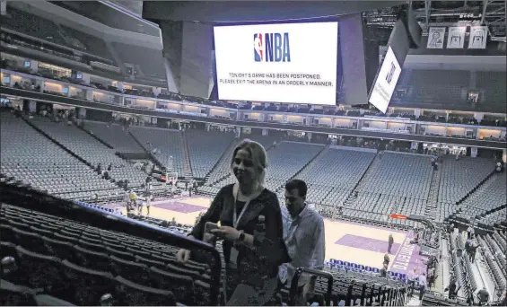  ?? Rich Pedroncell­i The Associated Press ?? March 11, 2020: Fans file out of the Golden 1 Center in Sacramento, Calif., after the NBA game between New Orleans and Sacramento was postponed because of the coronaviru­s.