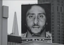  ?? ASSOCIATED PRESS ?? IN THIS SEPT. 5, 2018, file photo, a large billboard stands on top of a Nike store showing former San Francisco 49ers quarterbac­k Colin Kaepernick at Union Square in San Francisco.