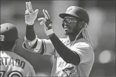  ?? DAVID DERMER/AP ?? TORONTO BLUE JAYS’ RAIMEL TAPIA celebrates after hitting a two-RBI single during the second inning in the first game of a doublehead­er against the Cleveland Guardians on Saturday in Cleveland.