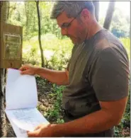  ?? EVAN BRANDT — DIGITAL FIRST MEDIA ?? Landowner Gary Westlake Sr. goes through the permits and management plans that must be posted at the site where lumber harvesting is underway.
