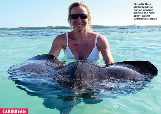  ??  ?? Fintastic time: Michelle Mone had an unusual start to the New Year – as she stroked a stingray CARIBBEAN